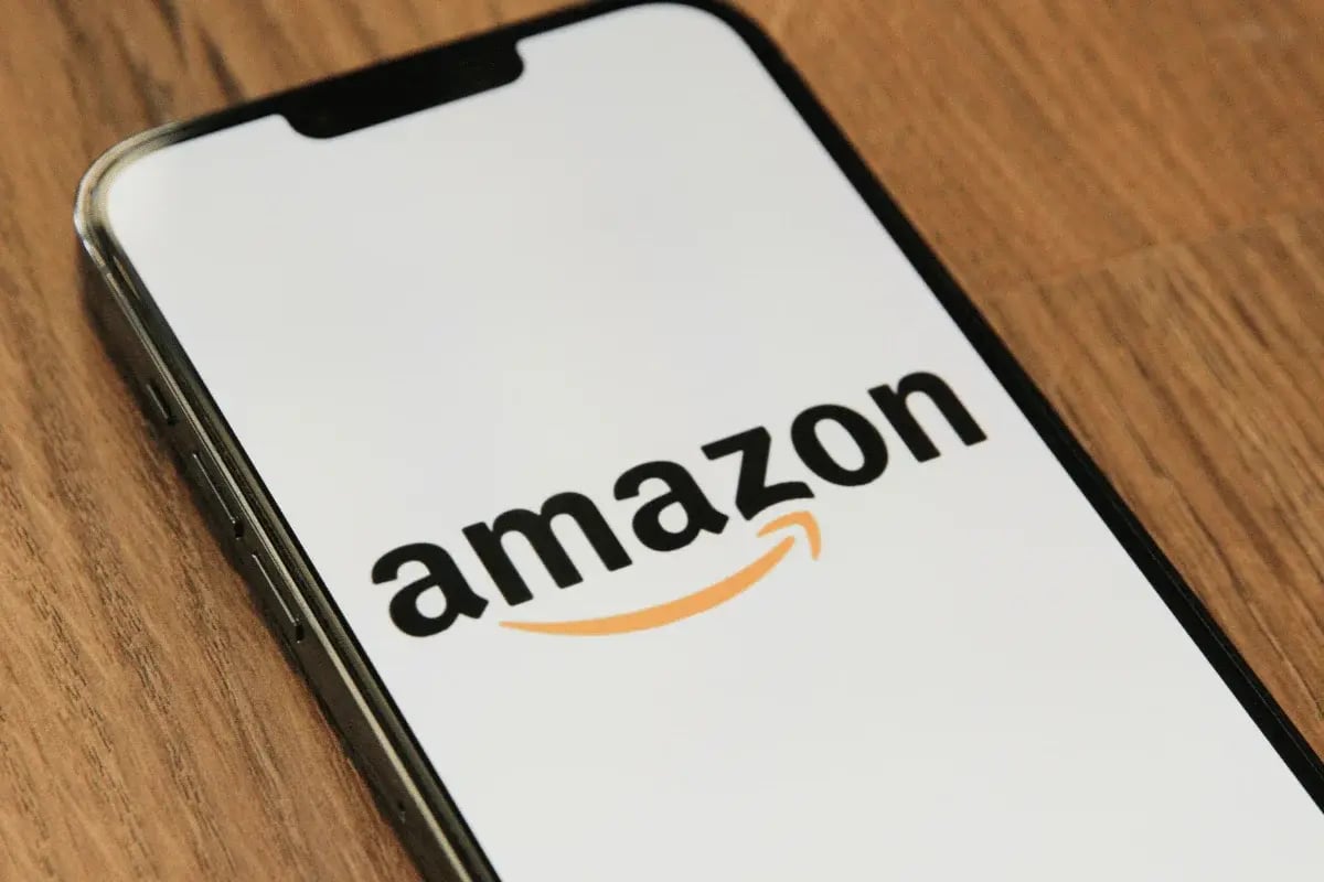 Amazon logo displayed on smartphone screen resting on table.