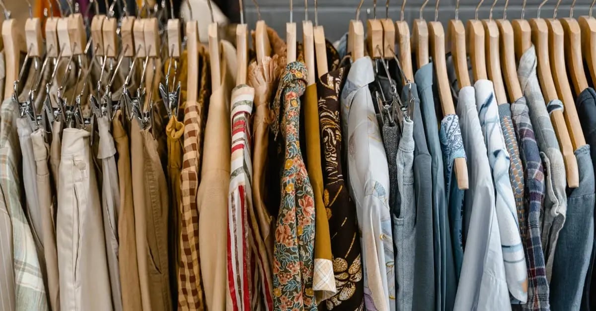 Clothing rack displaying amazon product variations in different colors, patterns, and styles on wooden hangers.